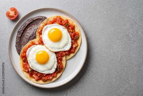 Huevos Rancheros Guatemaltecos - Fried Eggs with Tomato Salsa on Tortilla - With Copy Space