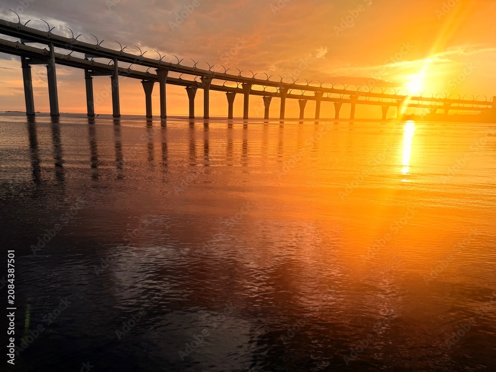Fototapeta premium impressive huge bridge in the sunset sea horizon, fantastic sea horizon