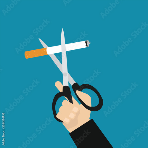 Foto Hand cutting cigarette using scissors