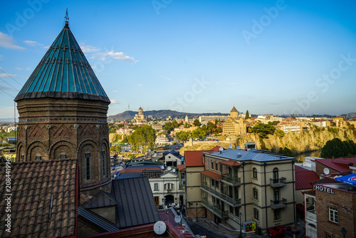 Historic Tbilisi cityscape view with Sioni Cathedral Bell Tower, Metekhi Church, and Holy Trinity Cathedral, Georgia.
