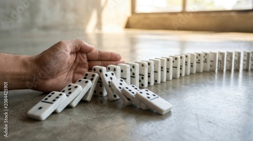 Hand stopping domino effect