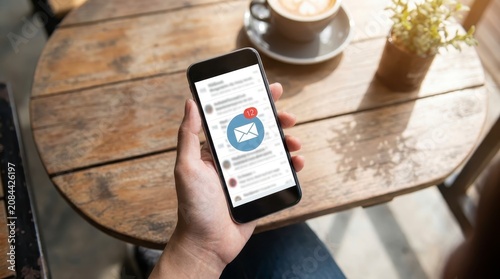 Person checking email notifications on smartphone