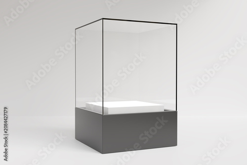 Obraz na plátně Empty glass display case showcase with black base and white podium isolated on light gray background