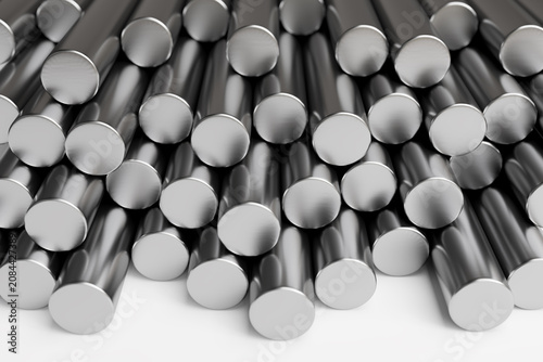 Quadro su tela Stack of steel round bars on white surface