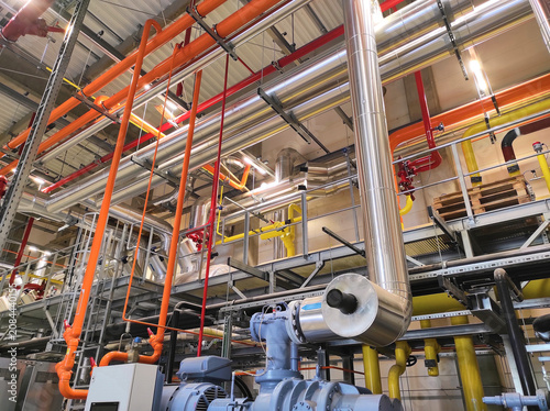 Complex piping and valves inside an industrial factory plant Boiler room or HVAC system