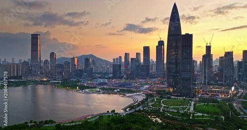 Aerial view of a modern waterfront city skyline with skyscrapers and Shenzhen Bay during sunset in Shenzhen, China