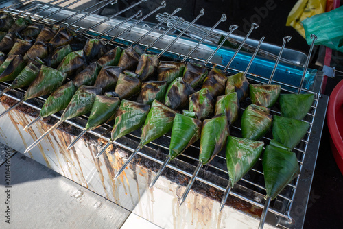 Traditional Malaysian Sata fish cakes wrapped in banana leaves grilled on skewers