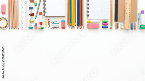 Top View of Assorted School and Office Supplies Arranged Neatly on a White Background, Ready for Creative Projects and Learning