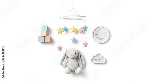 A whimsical baby mobile featuring a plush bunny, colorful stars, building blocks, and celestial-themed decor against a white background.