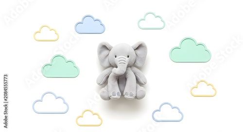 Cute grey plush elephant toy surrounded by pastel colored cloud shapes on a clean white background, perfect for a baby's nursery.