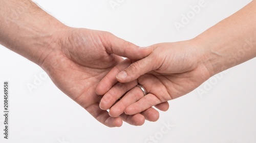 Couple holding hands with wedding ring symbolizing love and commitment