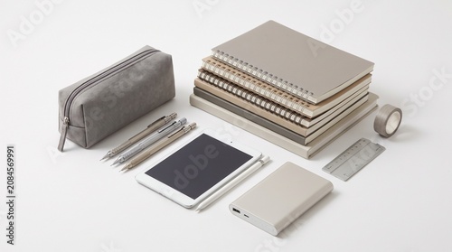 Modern Stationery and Gadgets Arranged on a White Background