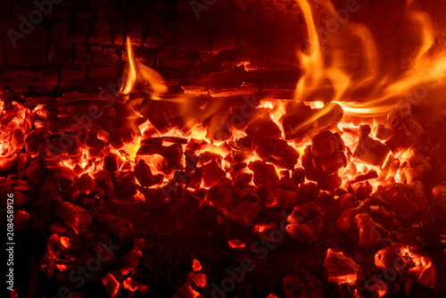 Fire in a fireplace in the living room with accessories