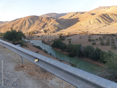 Cuadro en lienzo Moroccan river landscape with mountains and road at sunset