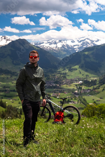 Man mountain biking in swiss alps enjoying outdoor adventure