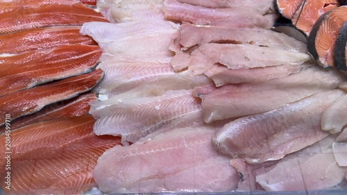 Fresh Salmon And White Fish Fillets Displayed On Seafood Market Counter