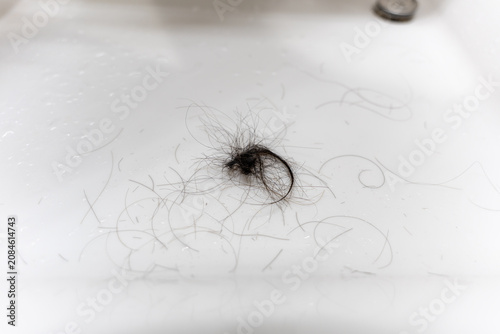 Fotografie Hair Clippings on White Sink