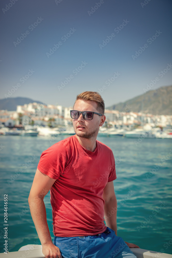 Fototapeta premium Man enjoying summer boat trip in harbor