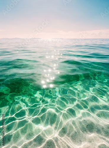 Crystal Clear Turquoise Sea with Sunlight Reflections and Gentle Waves