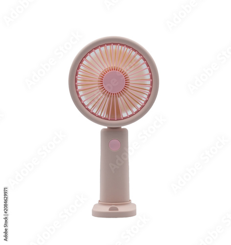 Portable pink handheld electric fan on a white background for cooling off on hot summer days