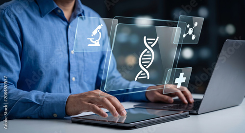 Scientist using tablet and laptop with dna helix and medical research symbols on digital screen interface.