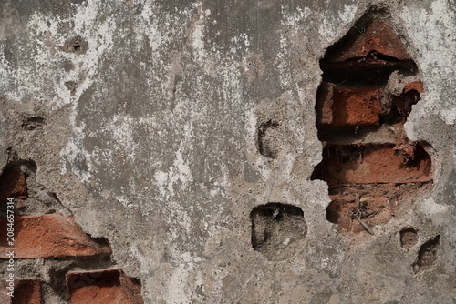 Old Peeling Plaster Wall with Exposed Red Bricks Texture