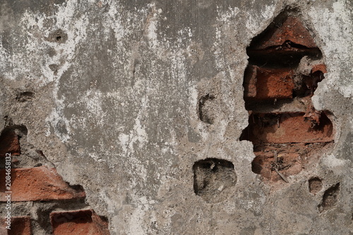 Old Peeling Plaster Wall with Exposed Red Bricks Texture