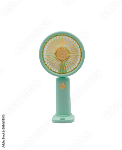 Portable green handheld electric fan on a white background for cooling on hot summer days