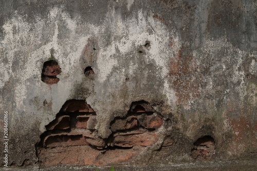 Old Peeling Plaster Wall with Exposed Red Bricks Texture