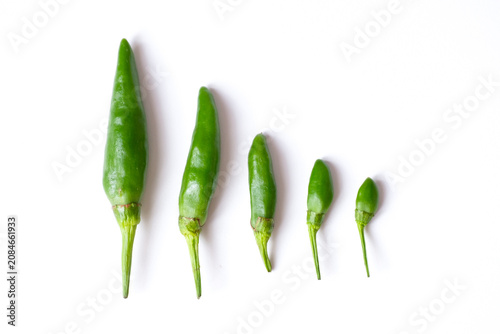 Billede på lærred Pattern of fresh green bird's eye chilies or cabe rawit hijau arranged in a grid