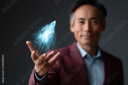 Businessman presenting a blue holographic rocket projection above his hand for innovation presentation background and pitch banner