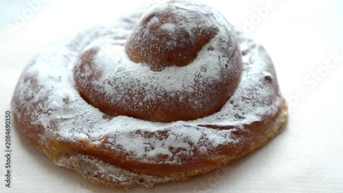 Rotating traditional ensaimada pastry on white background, top view, loopable
