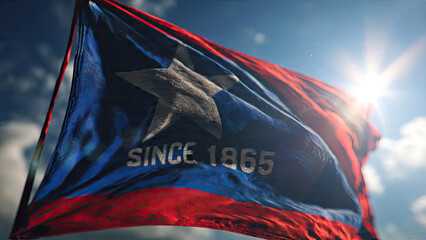 Juneteenth flag waving against a bright blue sky with sun flare.