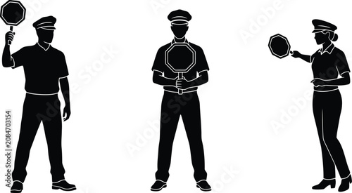 Fotografie Traffic control officers silhouettes holding stop signs directing road safety re
