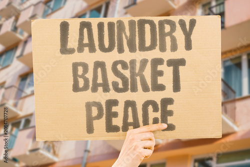 Bild auf Leinwand "Laundry basket peace" Shared chores become quiet diplomacy