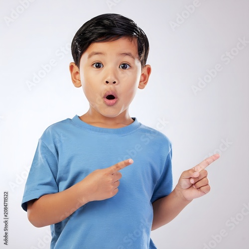 Surprised young man holding two smartphones.