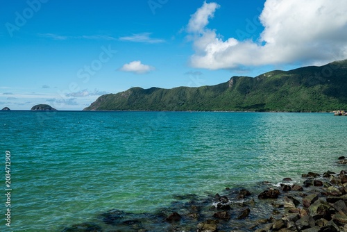 Photography Turquoise coastal bay and green forested headland viewed from Con Dao Island, Ba