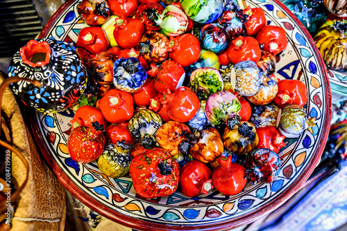 A brightly painted ceramic pomegranate, used for decoration in the Alcaicería market of Granada.