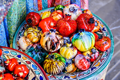 A brightly painted ceramic pomegranate, used for decoration in the Alcaicería market of Granada.