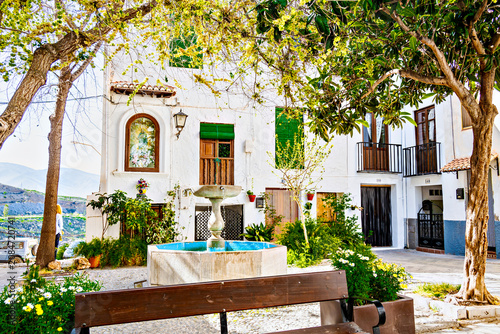 Beautiful Plaza Colorá in the historic Hondillo neighborhood of Lanjarón, with its white houses and flowerpots. Alpujarra region, Granada.