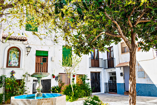 Beautiful Plaza Colorá in the historic Hondillo neighborhood of Lanjarón, with its white houses and flowerpots. Alpujarra region, Granada.
