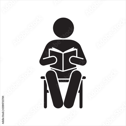 Person reading a book on a chair with black and white learning education