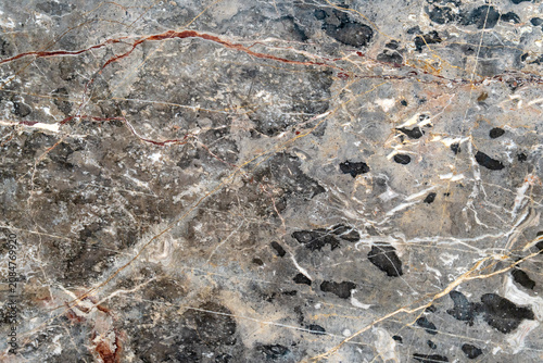 High-resolution close-up of natural gray marble surface with veins, cracks, and mineral patterns, ideal for design, architecture, and backgrounds.