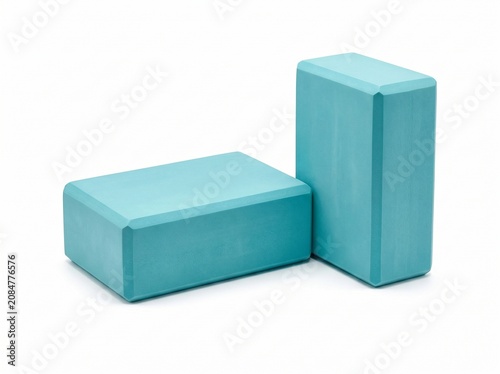 Turquoise yoga blocks on white background, foam exercise bricks, fitness equipment for pilates