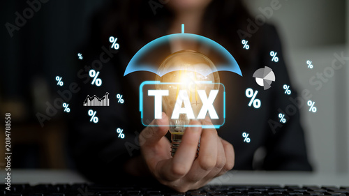 Photos Business Person Holding Light Bulb Under Umbrella with Tax Concept Illustration and Percentage Symbols in Modern Office Setting