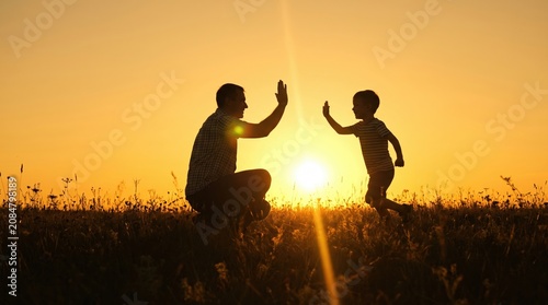 Father giving son high five. Parent child relationship concept
