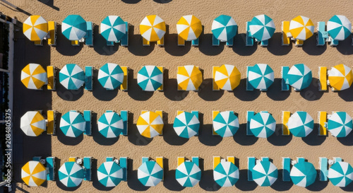 Beach Umbrellas And Loungers Arranged In Rows On Sand