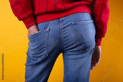 Bild auf Leinwand A strong man's ass in classic blue jeans in close-up