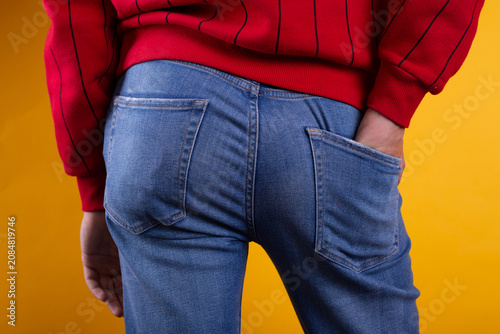 Quadro su tela A strong man's ass in classic blue jeans in close-up