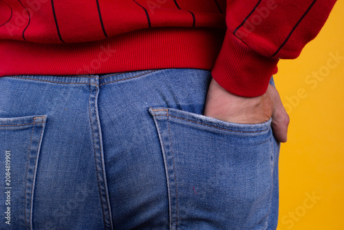 Bild auf Leinwand A strong man's ass in classic blue jeans in close-up